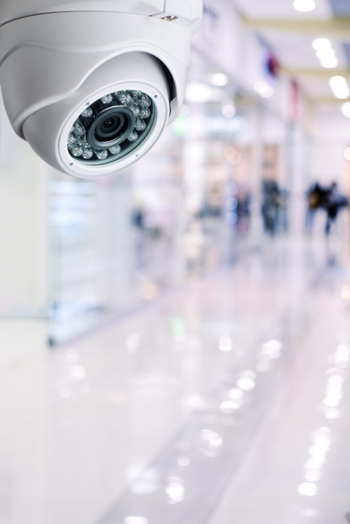 Cctv camera security system on a ceiling of a shopping mall blurred background.